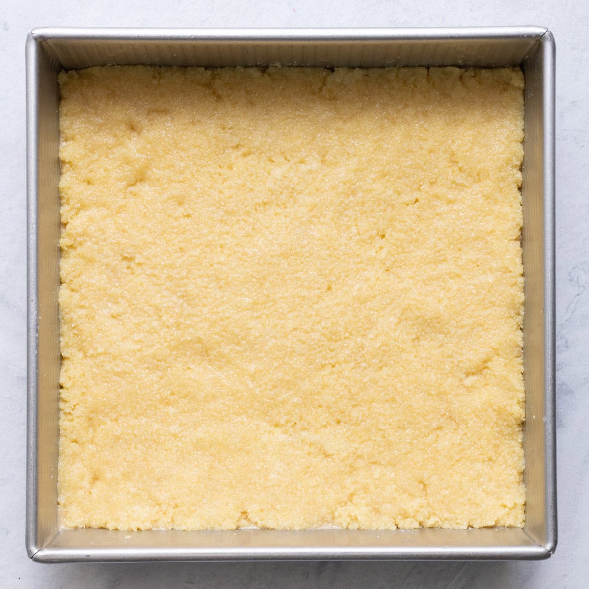 Namoura mixture spread out in a baking pan.