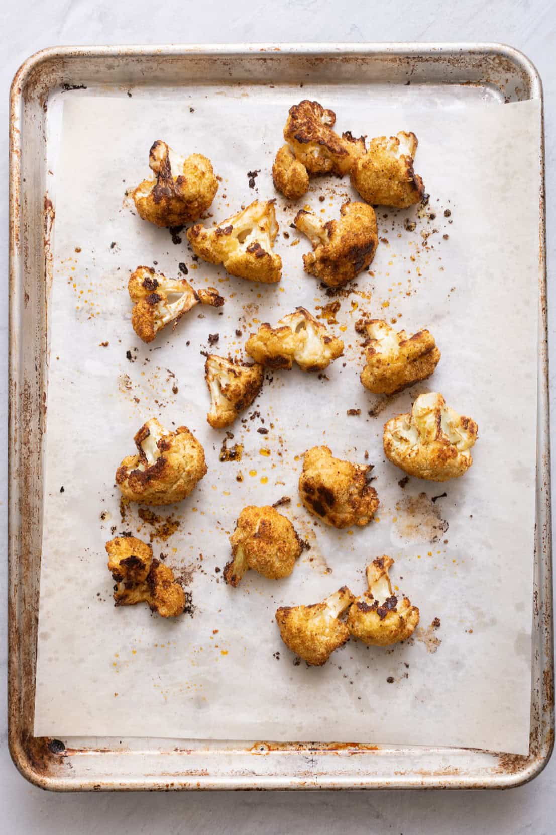 Roasted cauliflower on a baking sheet.