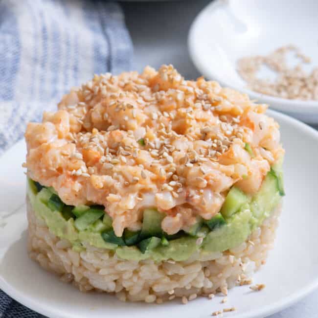 Sushi shrimp stack made with spicy mayo shrimp, avocado, cucumbers and rice