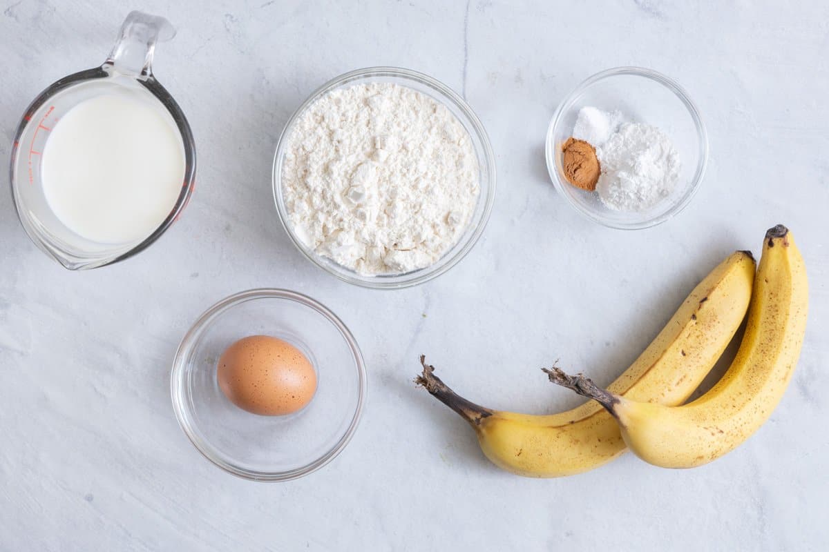 Ingredients for pancake recipe: milk, flour, egg, banana, cinnamon, salt, and baking powder.