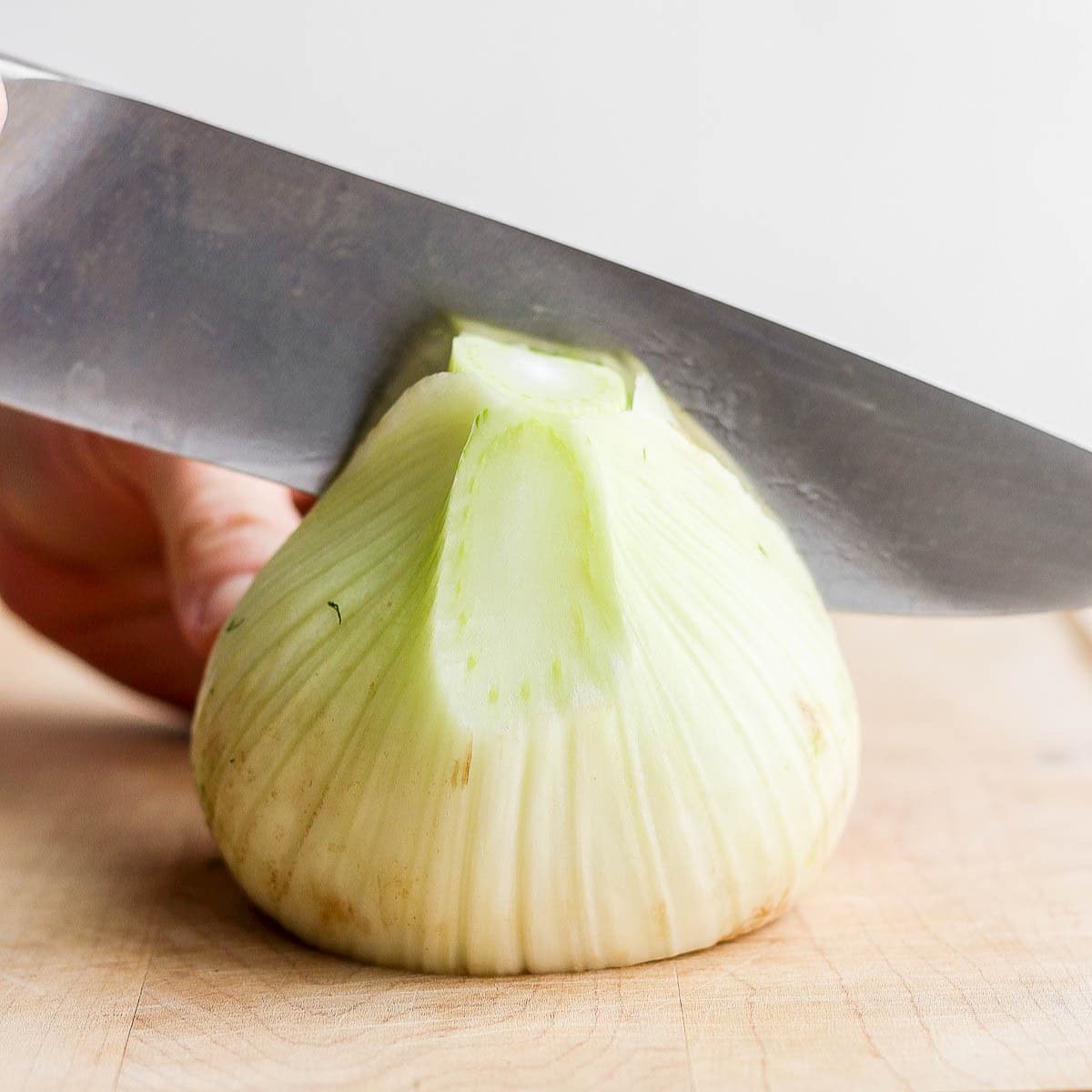 Cutting the fennel in half.