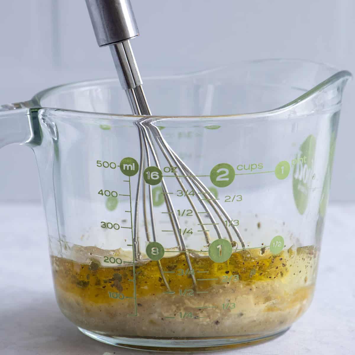 Dressing ingredients in a glass measuring cup before combining.