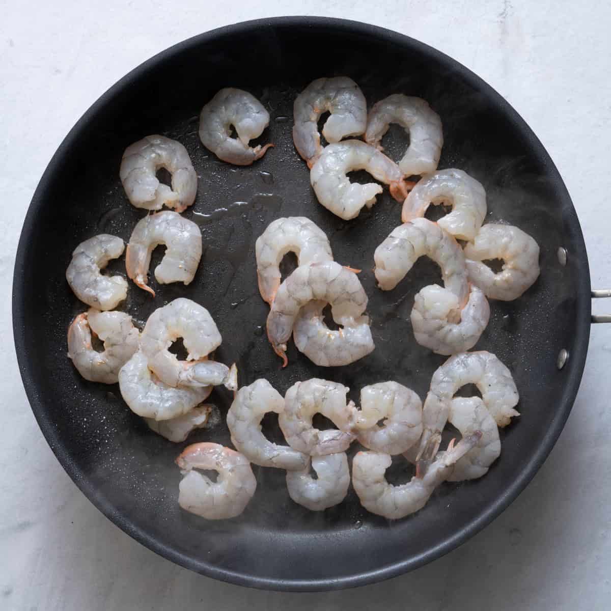 Shrimp on skillet before cooked.
