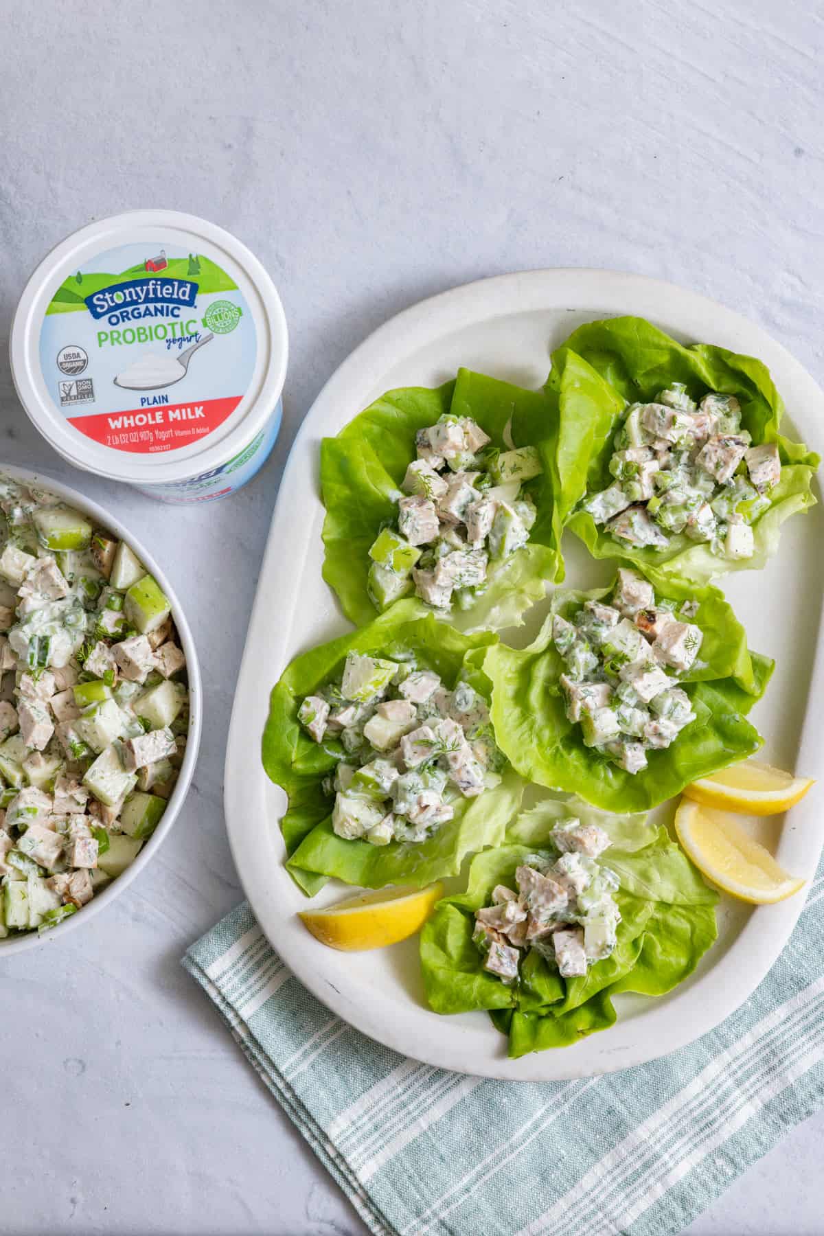 Top view of chicken salad in tubs of lettuce with Stonyfield yogurt.