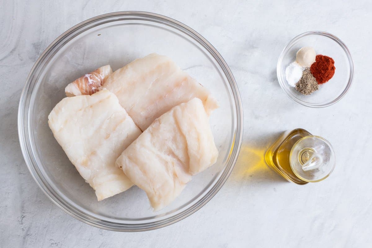 Ingredients for recipe: 4 raw cod filets, olive oil, and seasonings.