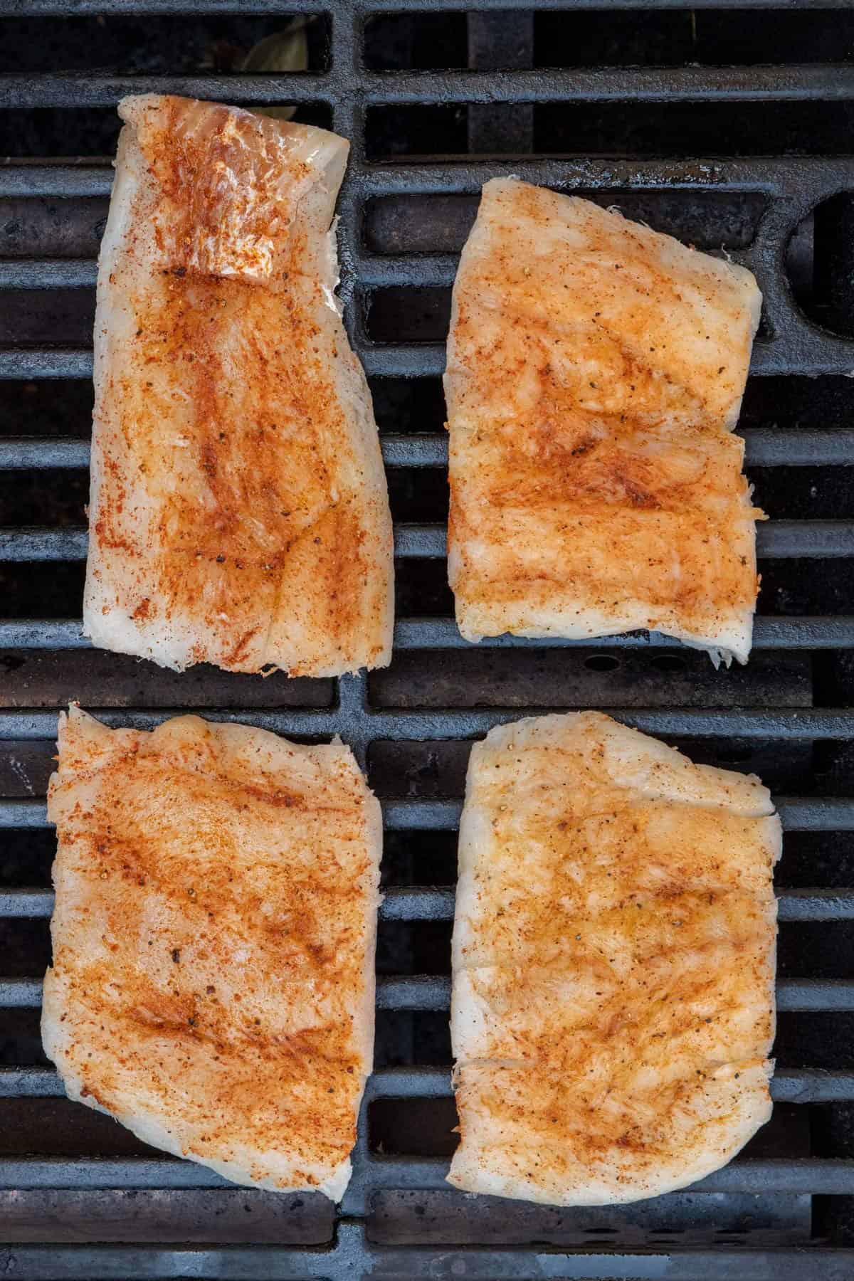 Cod on grill before grilling.