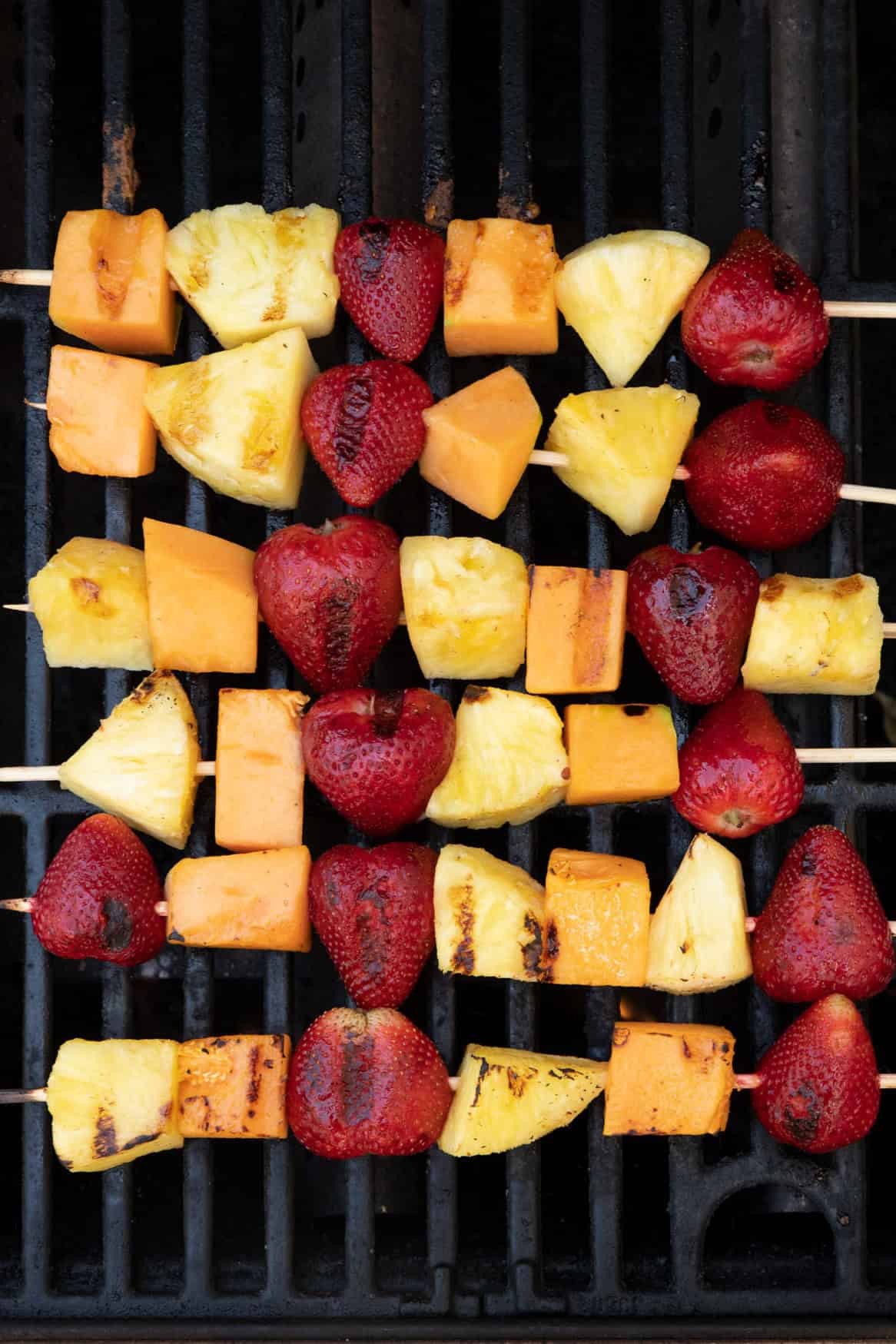 Kabobs flipped on a grill to show grill marks.
