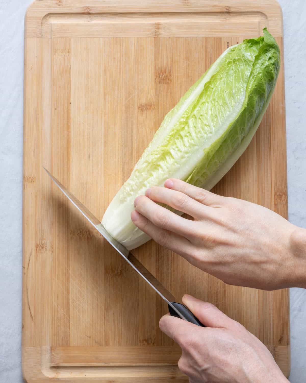 Trim inch from lettuce heart on cutting board.
