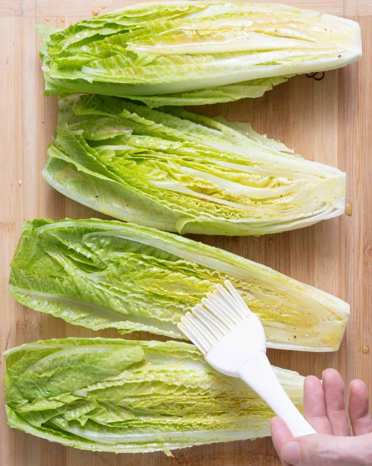Brush dressing on lettuce.