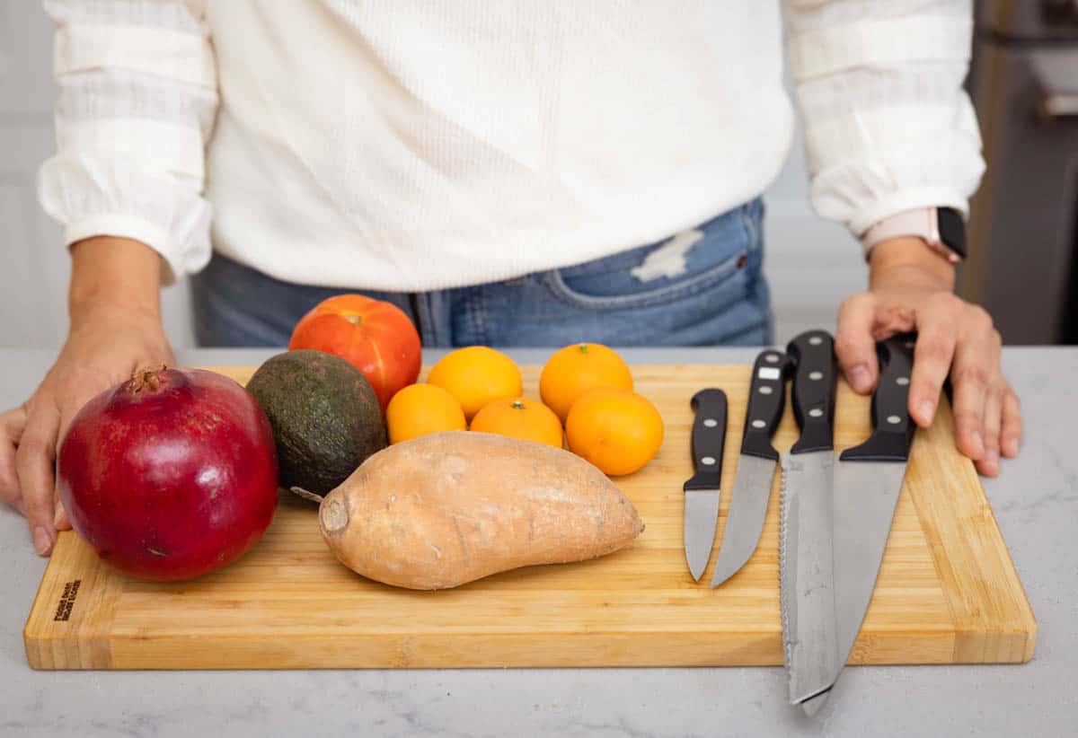 5 types of knives on cutting board with different produce