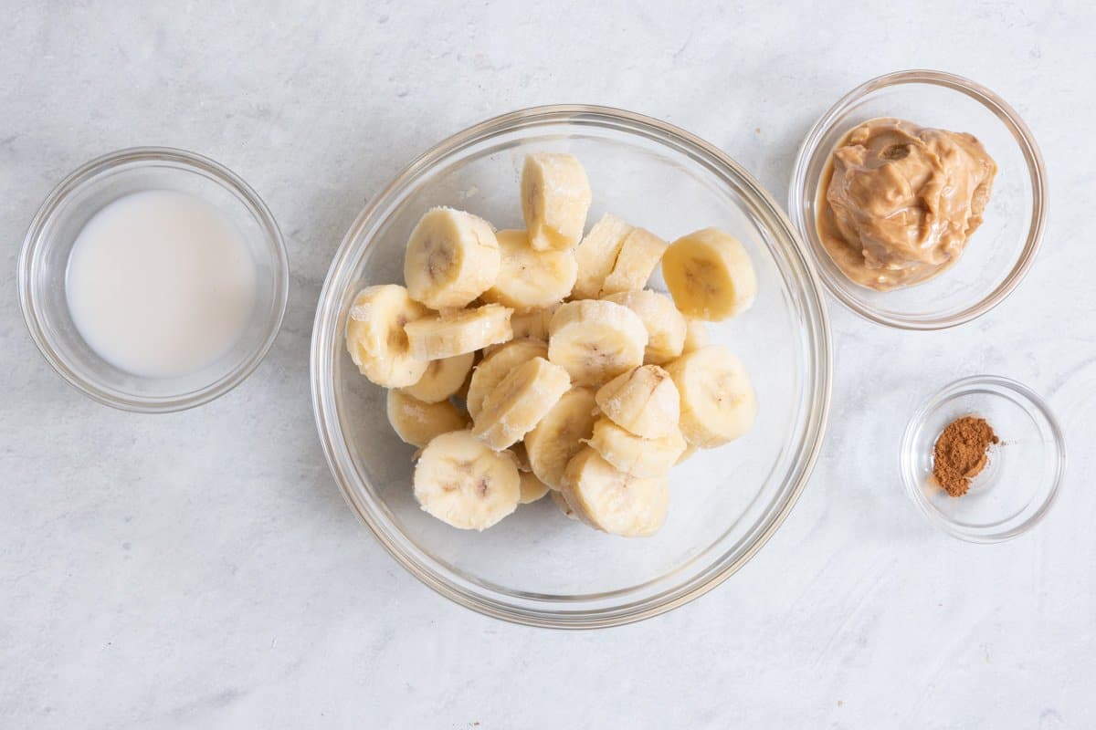 Ingredients for recipe: almond milk, bananas, peanut butter, and cinnamon.