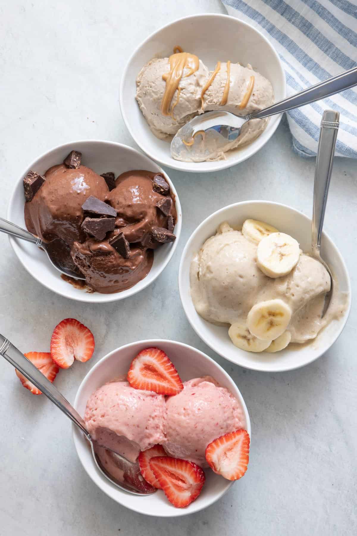 4 individual bowls with spoons of different flavored Nice Cream.