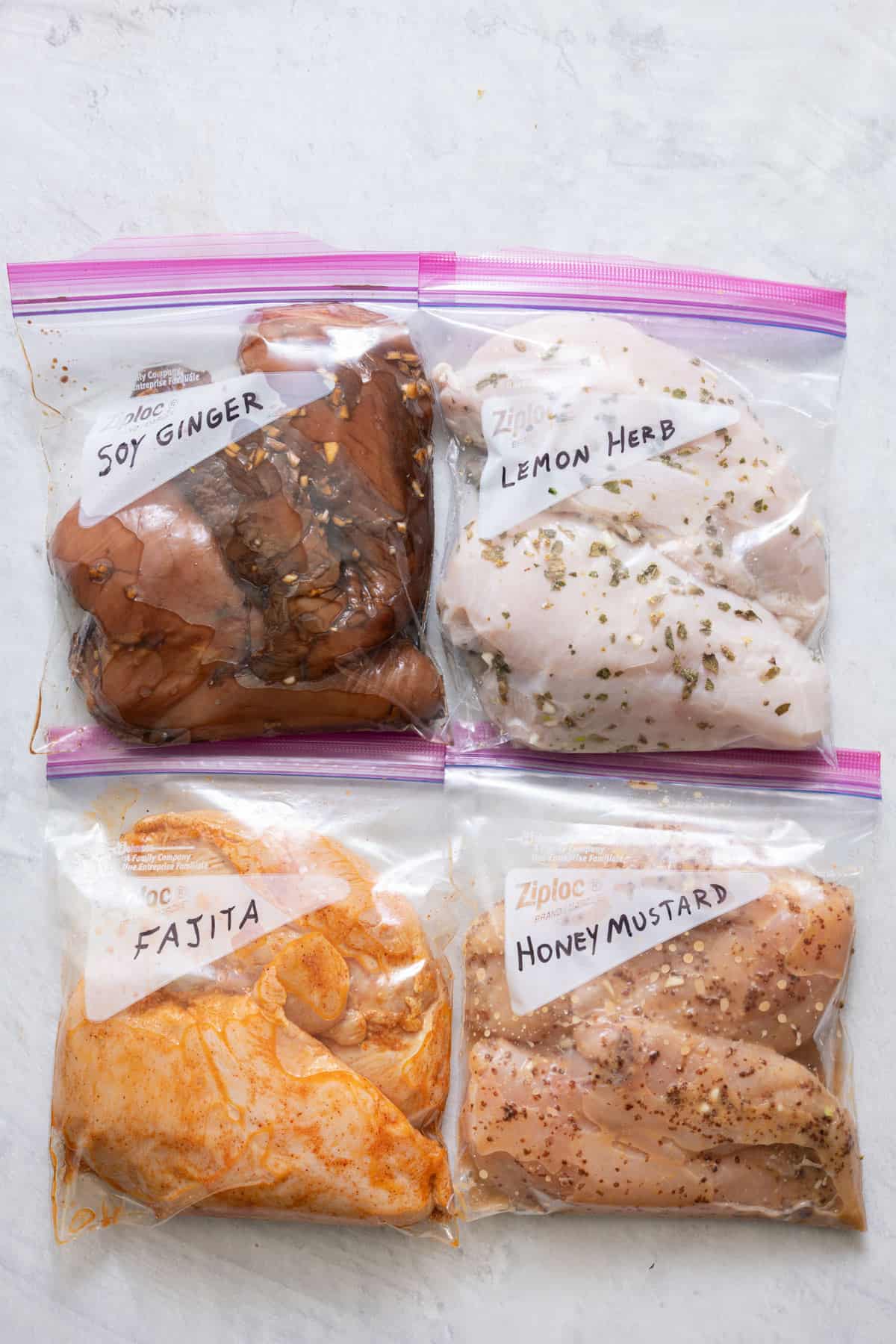 4 zip top bags with 2 chicken breast each in different marinades: soy ginger, lemon herb, fajita, and honey mustard.