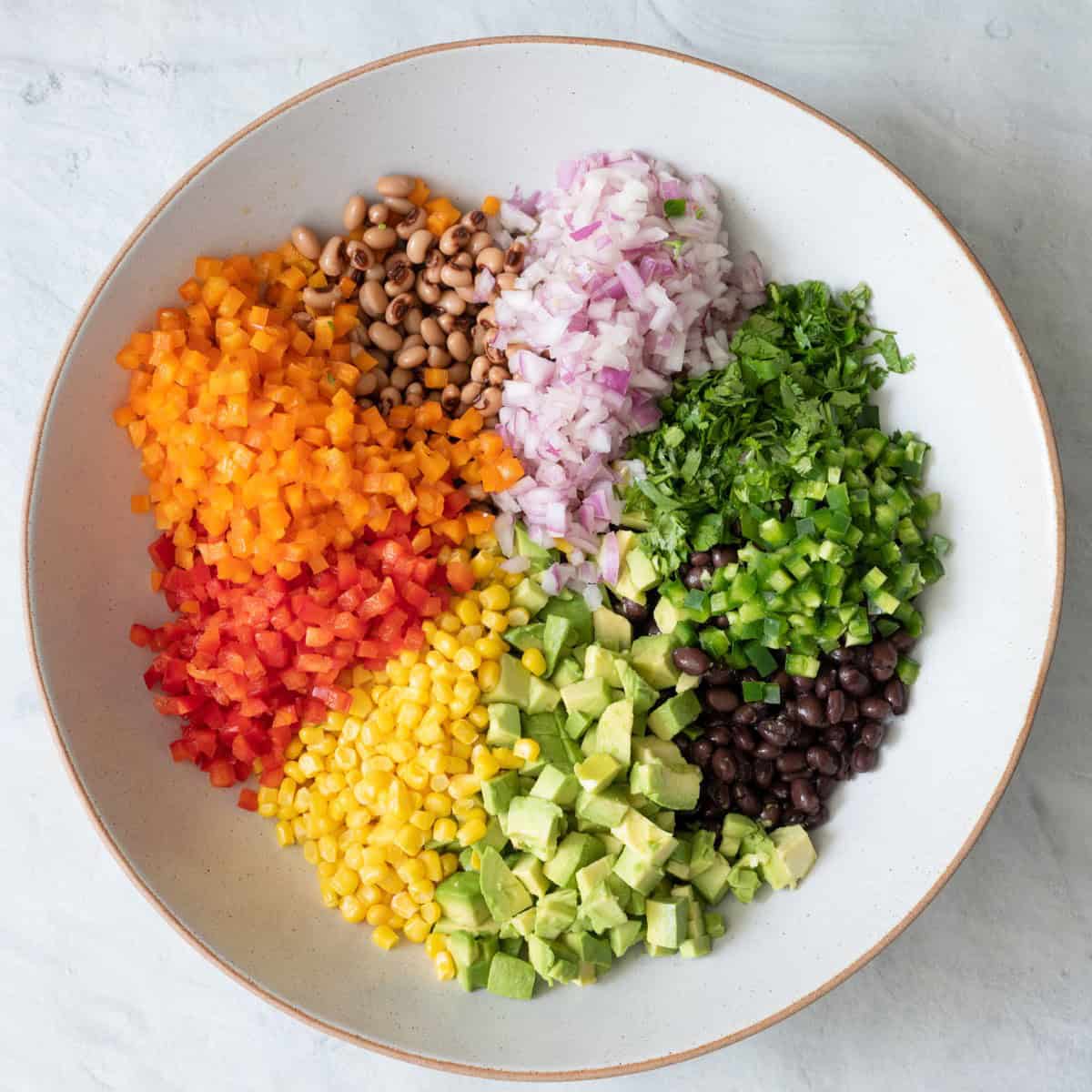 Ingredients in large shallow below partitioned into groups.
