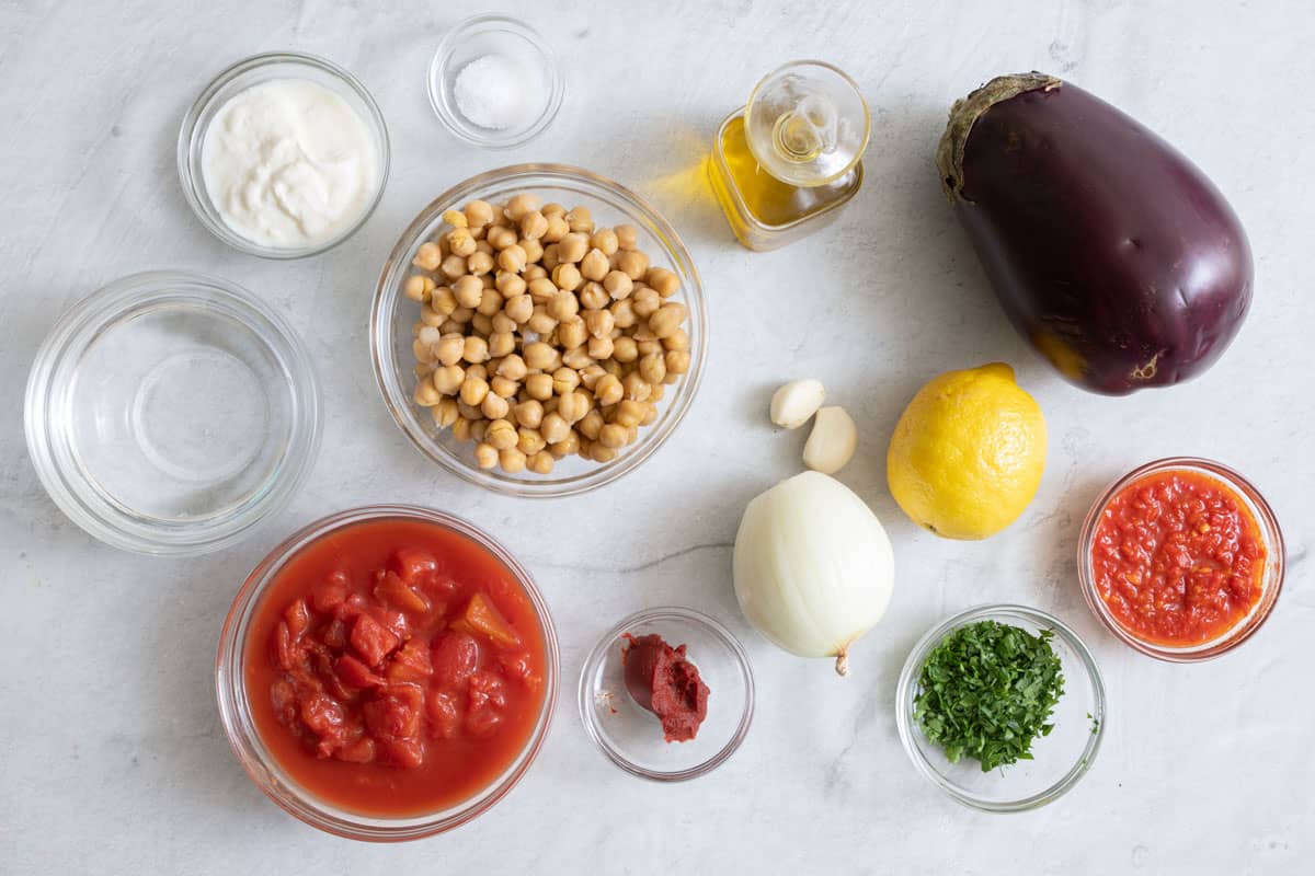 Ingredients for recipe: oil, eggplant, onion, garlic, harissa, tomato paste, diced tomatoes, chickpeas, water, lemon juice, yogurt, and parsley.