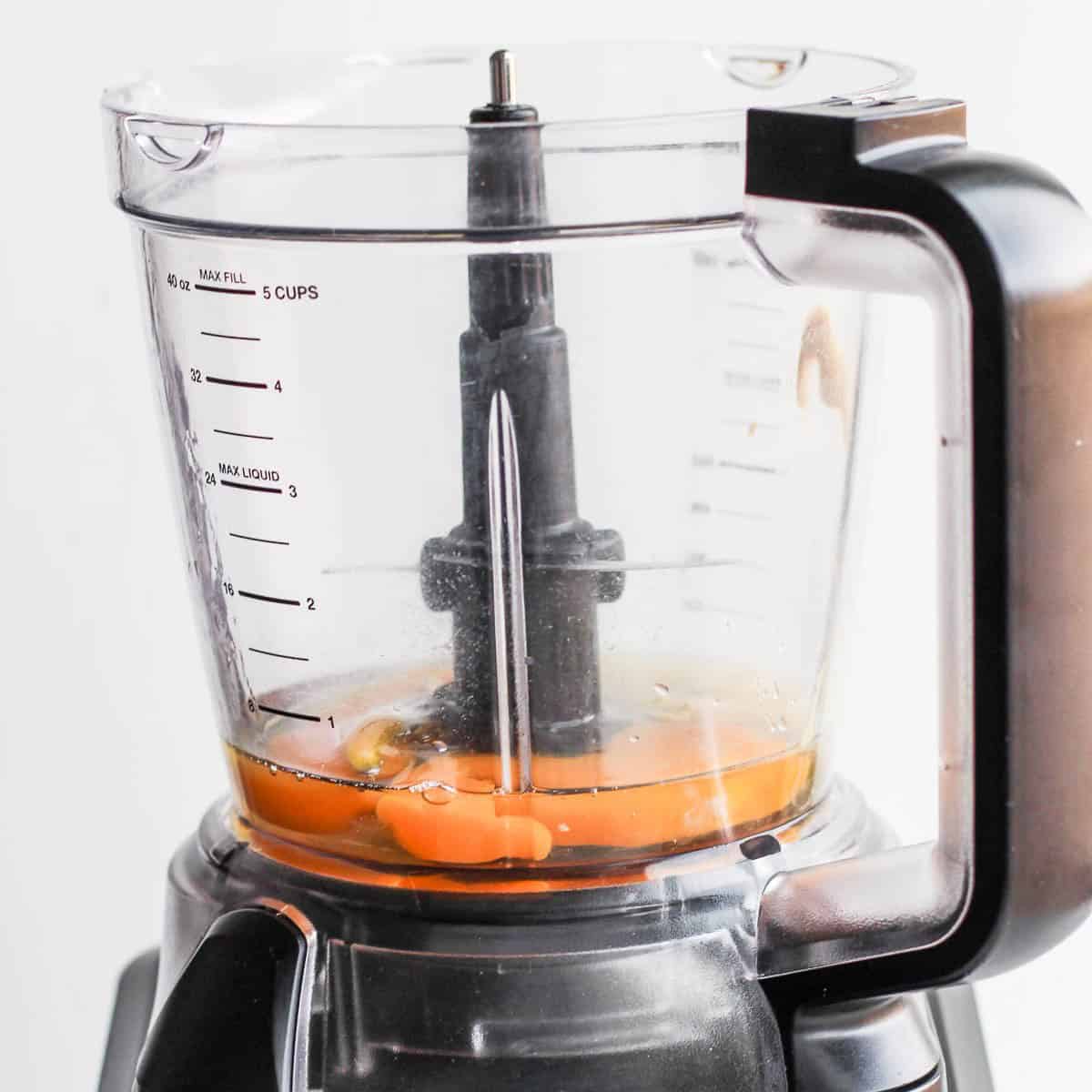 Eggs, lemon juice and mustard in food processor.