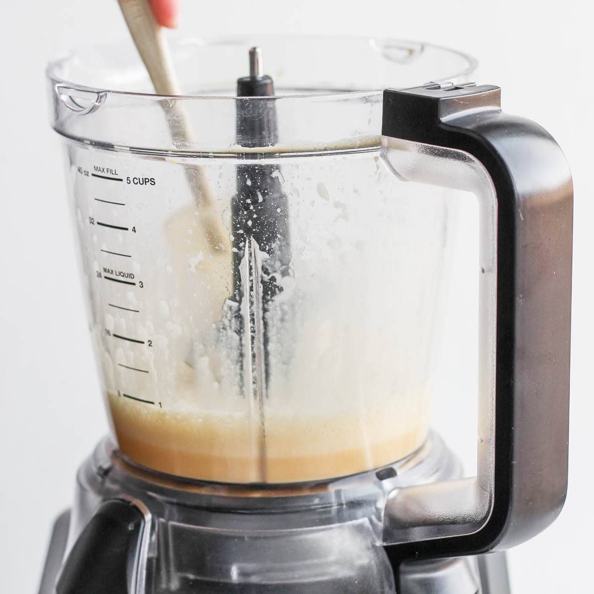 Scraping down sides.