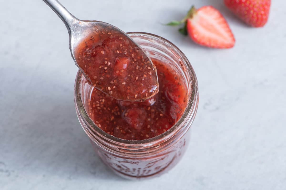Strawberry chia jam being scooped by a spoon