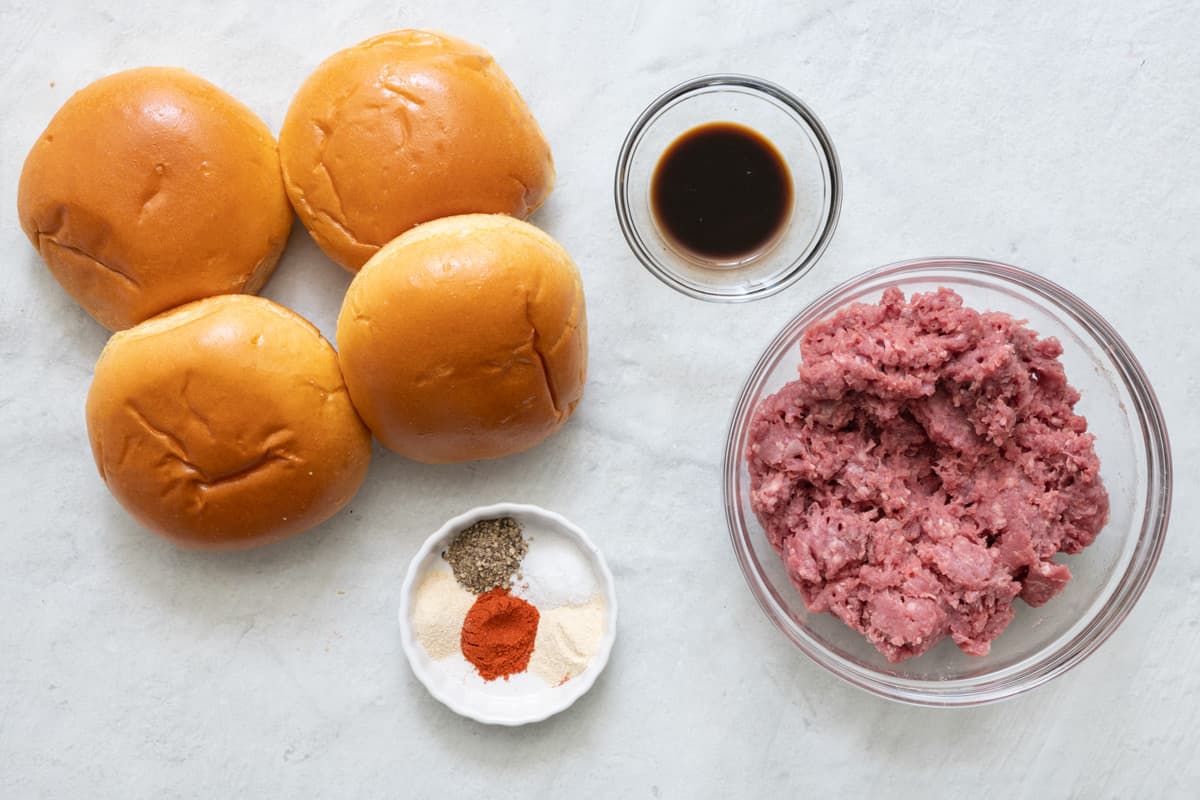 Ingredients for recipe before being prepped: 4 burger buns, seasonings, Worcestershire sauce, and ground beef.
