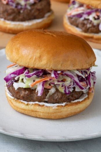 Side view of coleslaw on a burger.