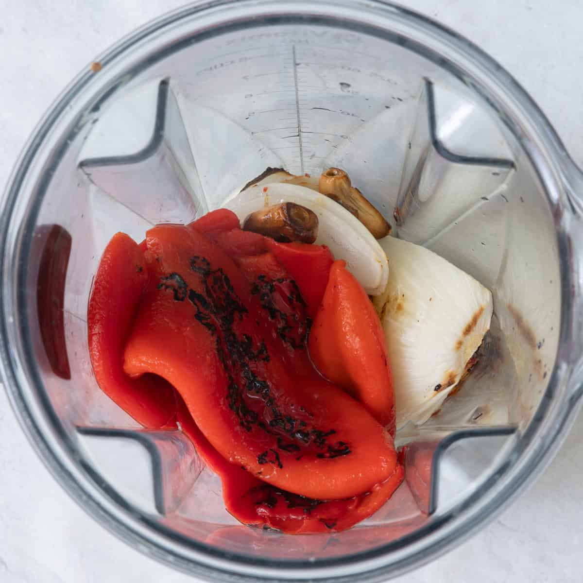 Onions and garlic in blender along with roasted red pepper and milk before blending.
