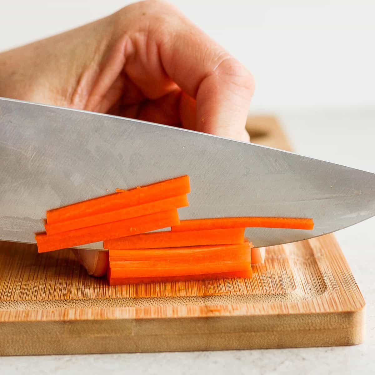 Cutting carrots into strips.
