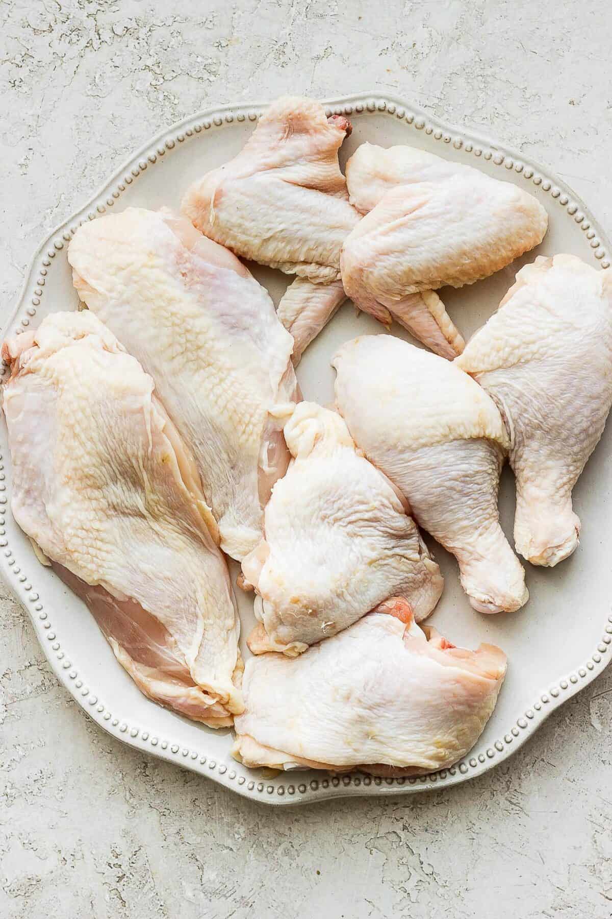 All the pieces together on a wide plate to show the different parts of the chicken.