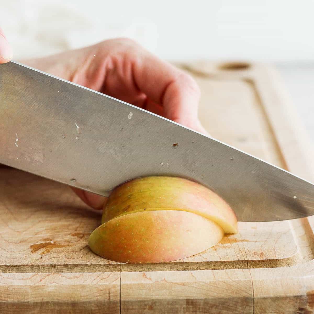 First wide piece down on cutting board, and cutting that piece into 4-5 slices.