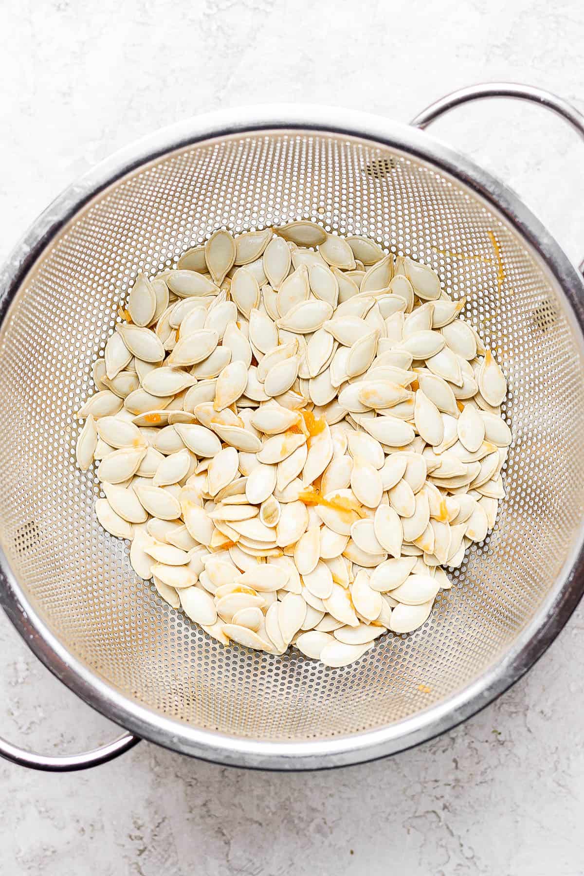 Colander with the pumpkin seeds after removed from pumpkin.