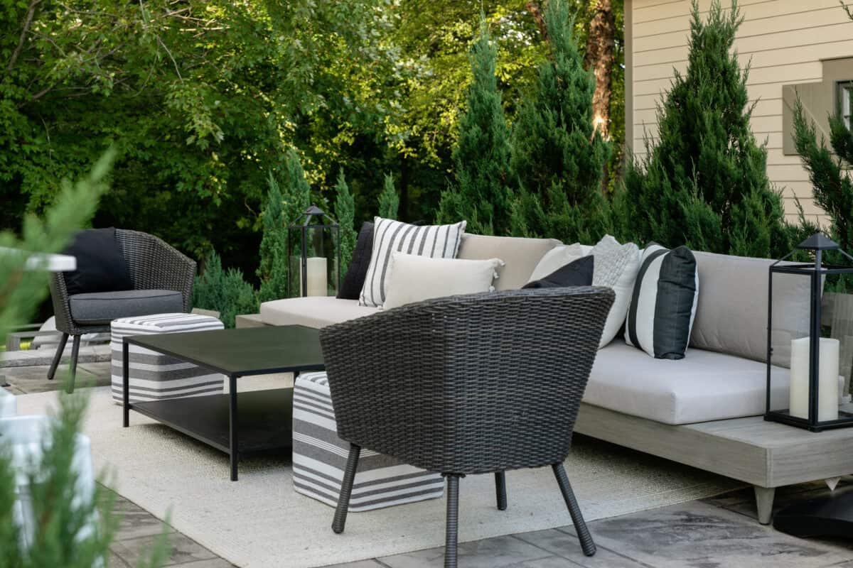 Picture of the patio lounging area with outdoor furniture, rug and pillows