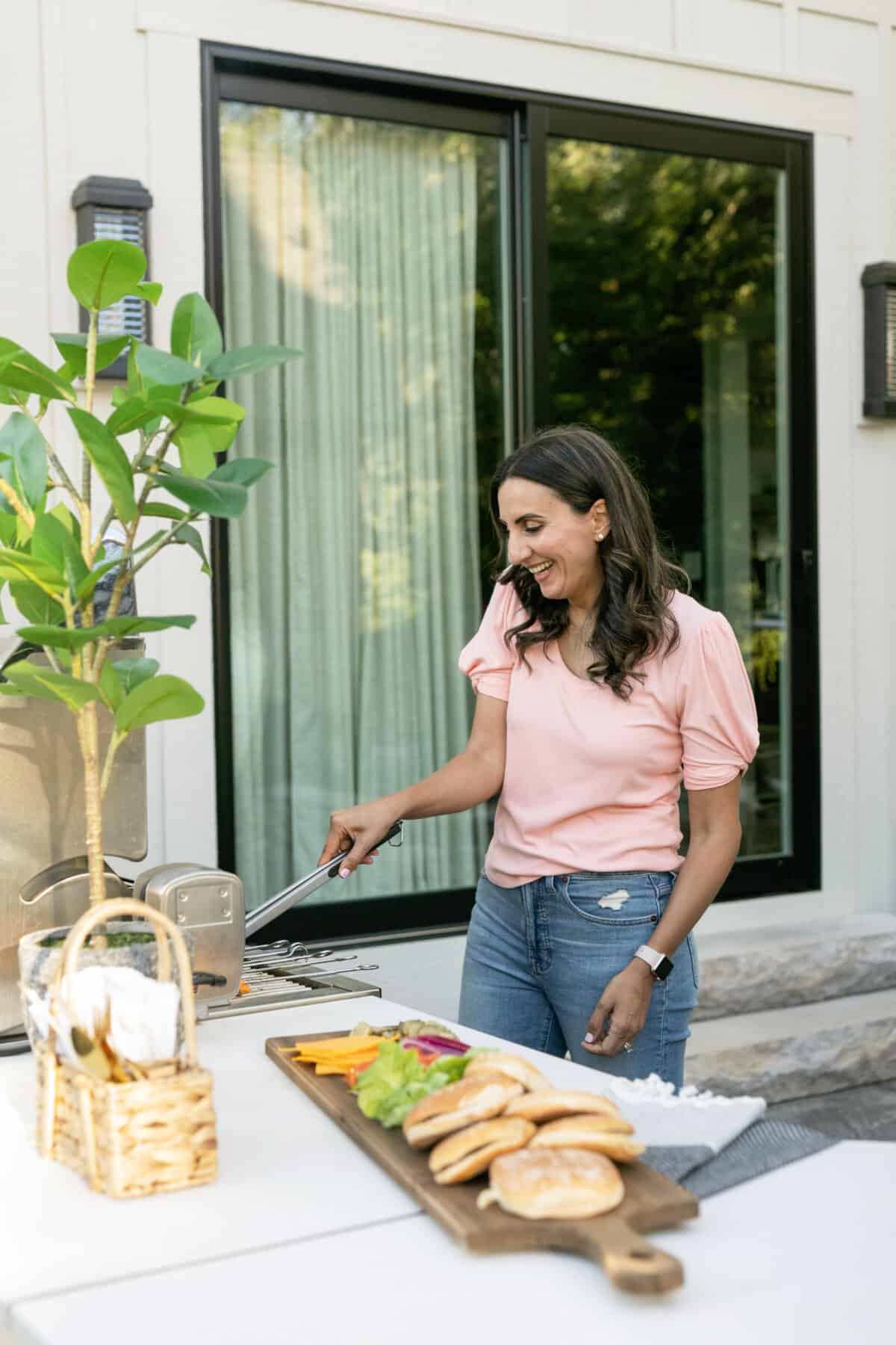 Yumna grilling outside in outdoor kitchen patio