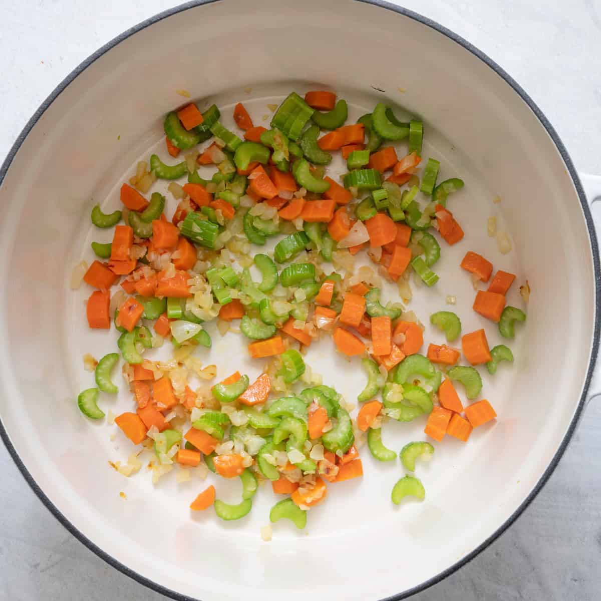 Onion, celery, and carrot in pot.