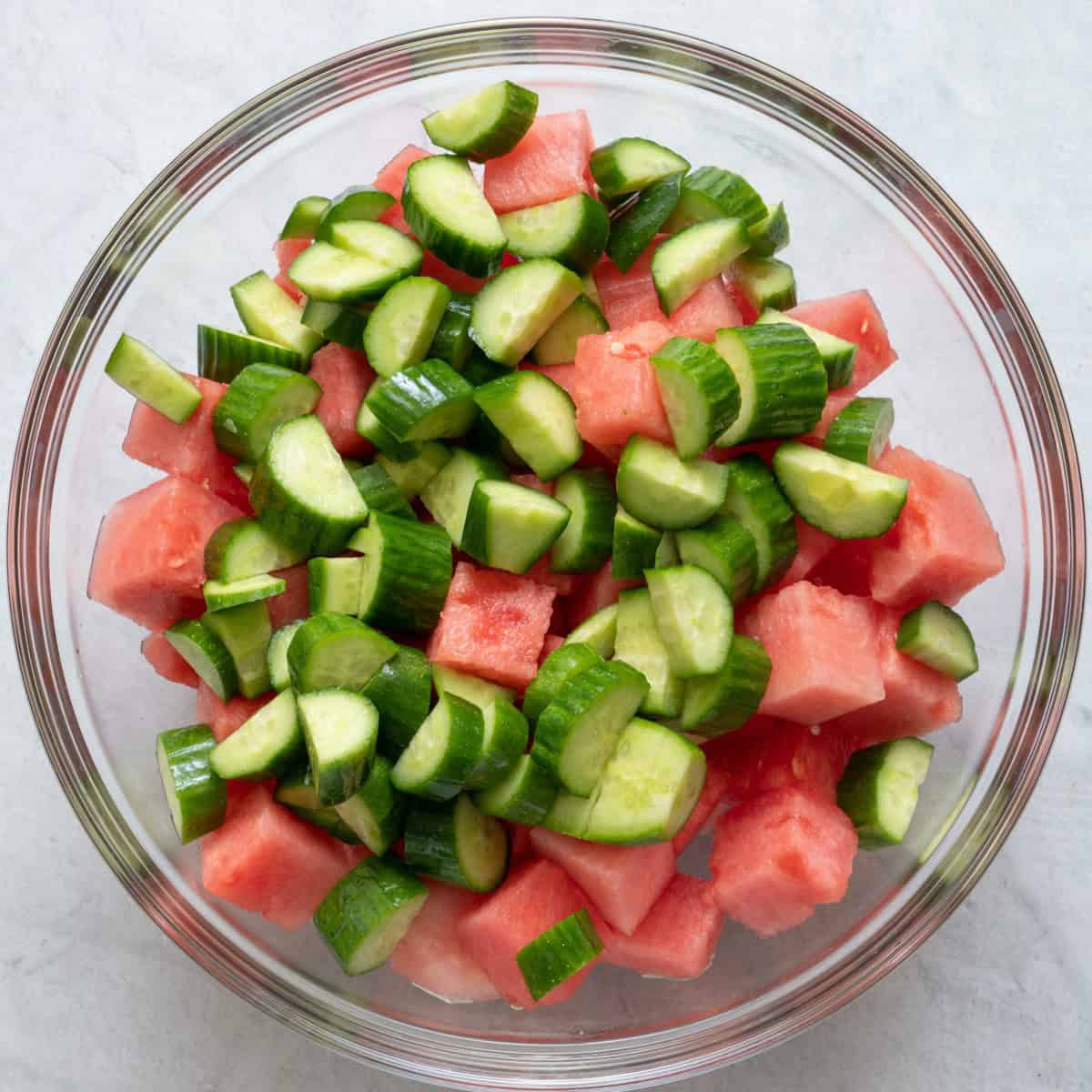 Watermelon and cucumber in large bowl.