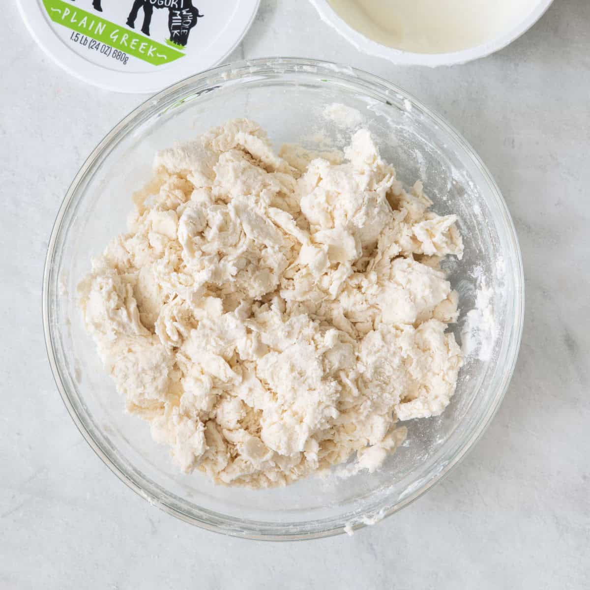 Greek yogurt mixed with flour in a bowl so that it created a dough.
