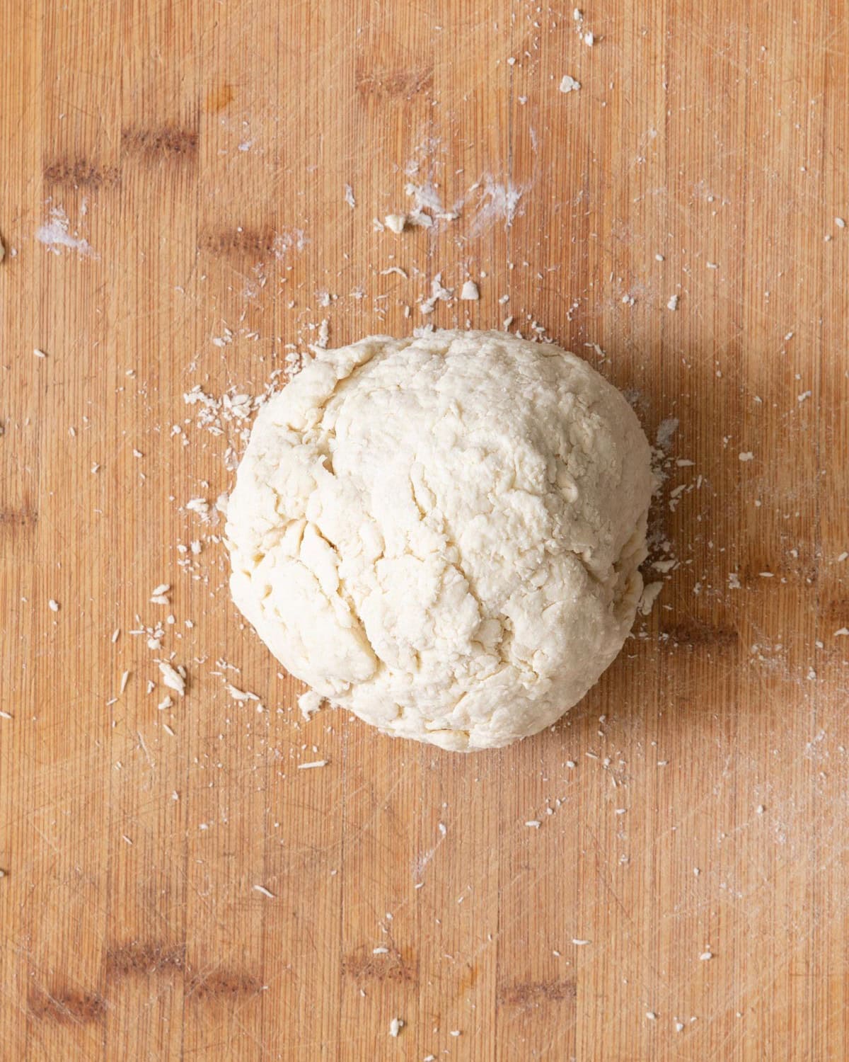 The pizza dough after removing it from the bowl and rolling it into one large ball.