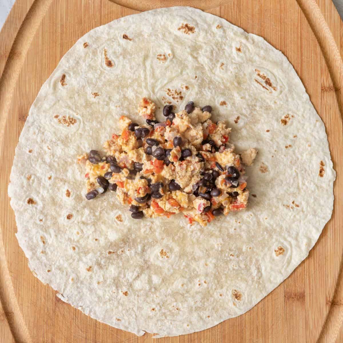 Egg mixture on tortilla before closing it.