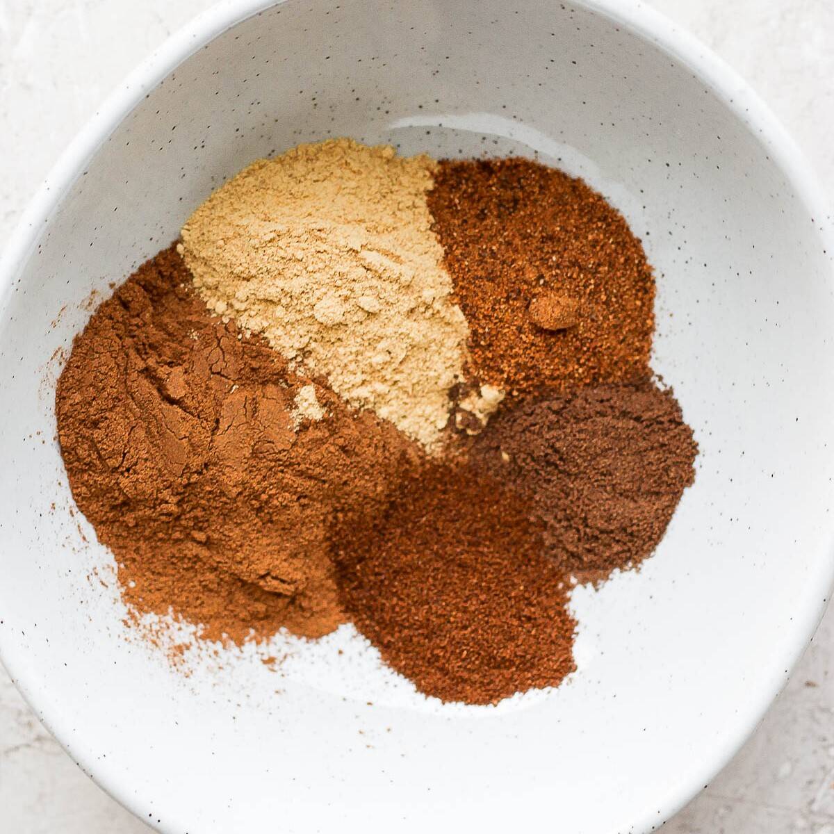 Spices in shallow bowl showing the individual ones separated.