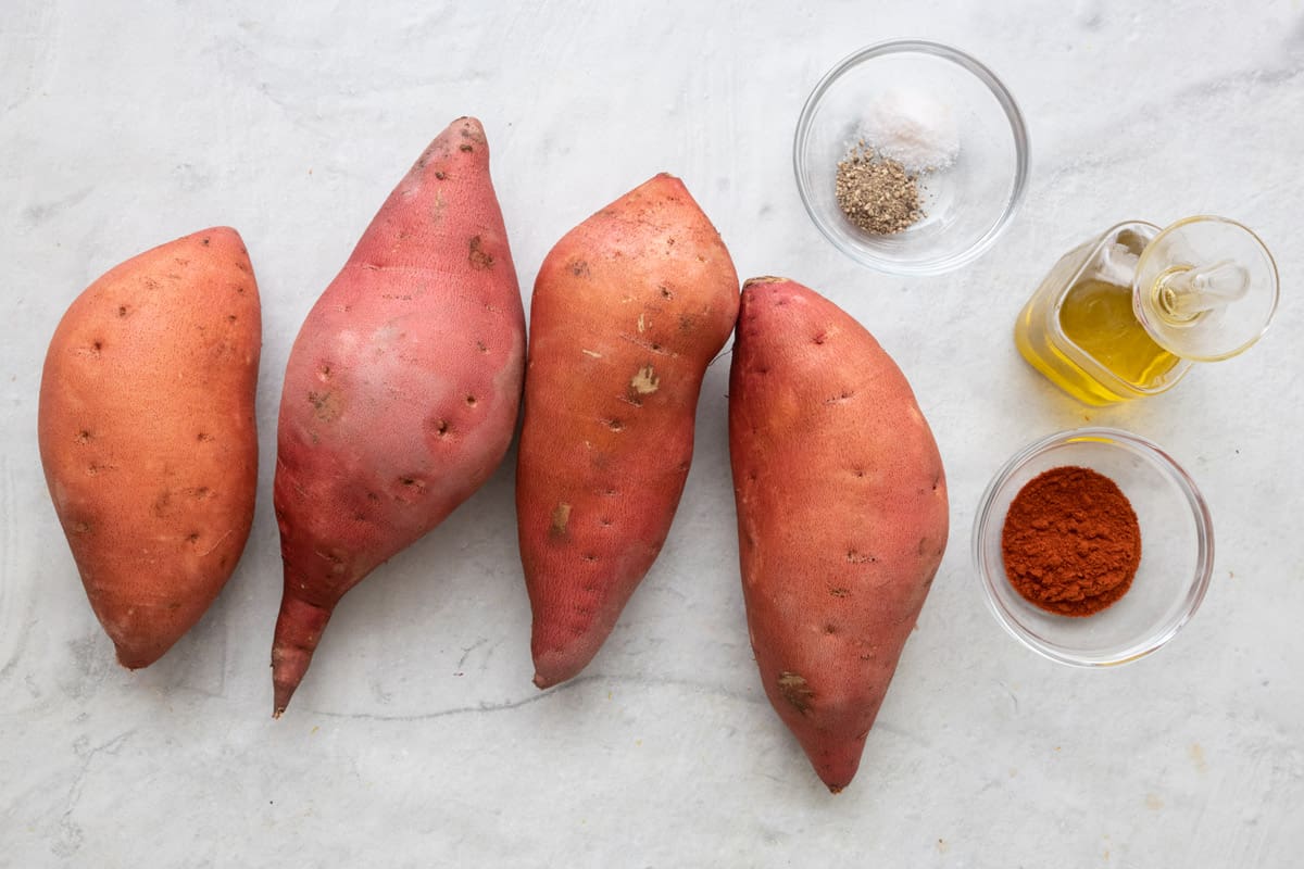 Ingredients for recipe before being prepped: 4 sweet potatoes, salt and pepper, oil, and paprika.