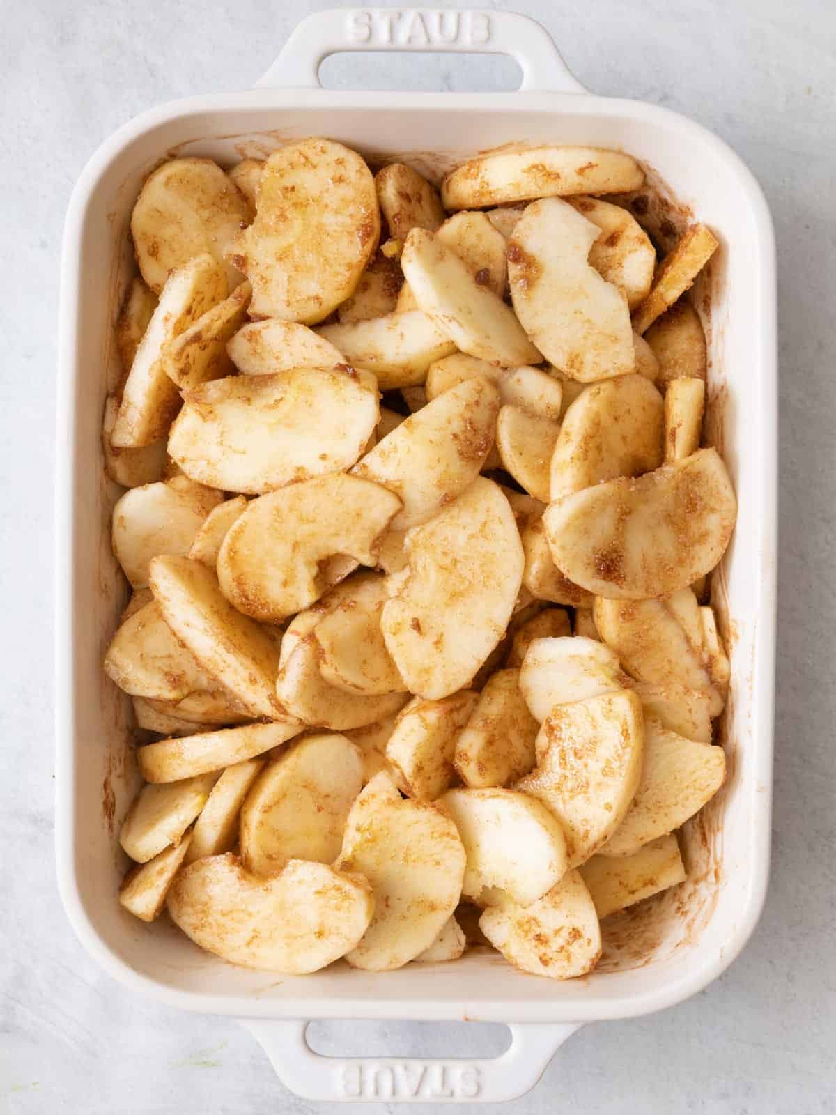 Apples tossed with butter mixture before baking.