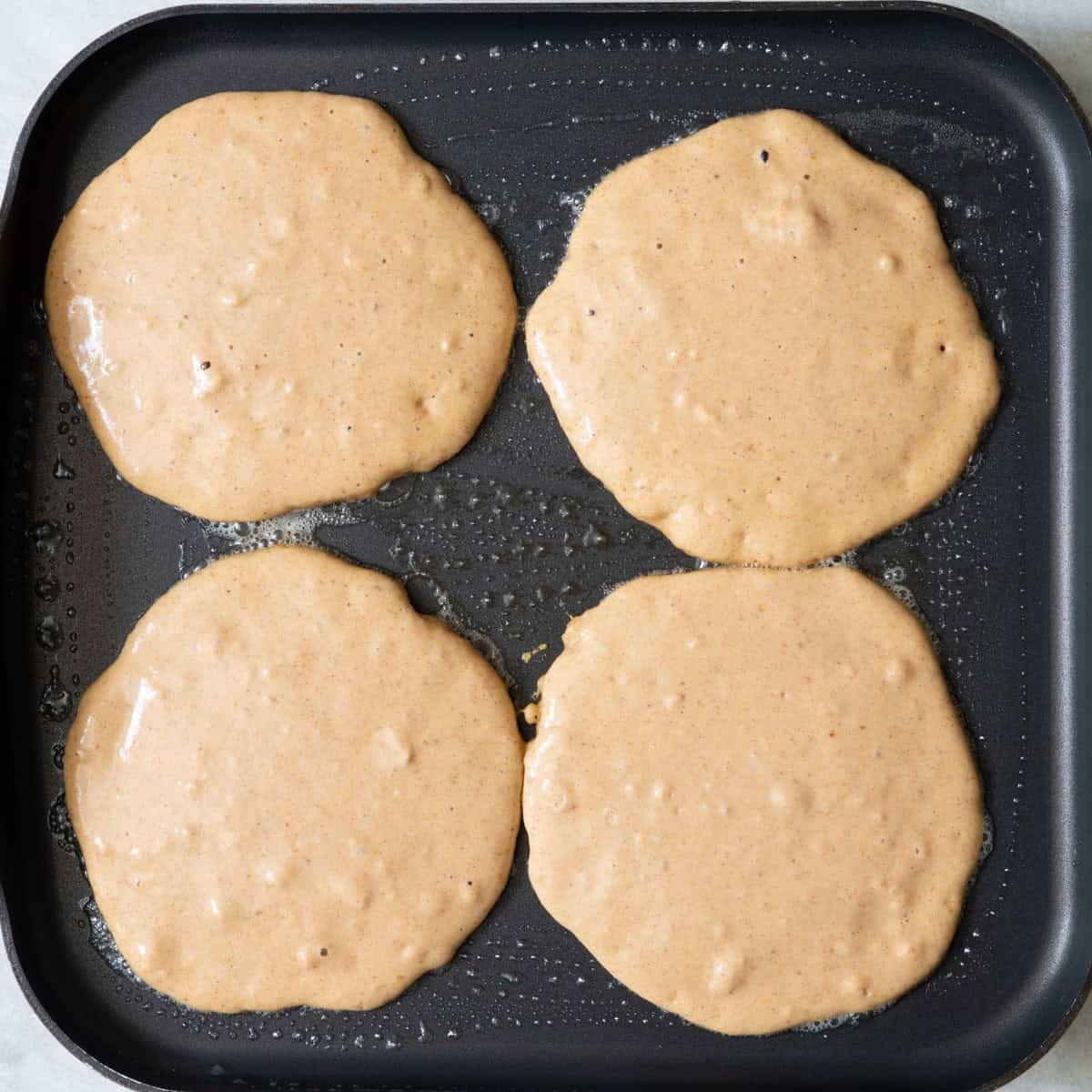 Pancakes on pan before cooking.