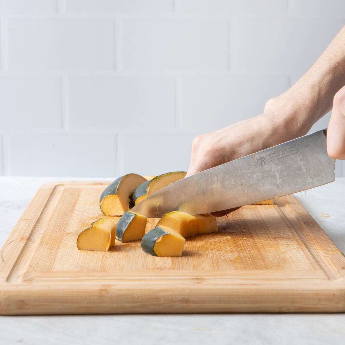 A few wedges on cutting board, starting to cut cubes.