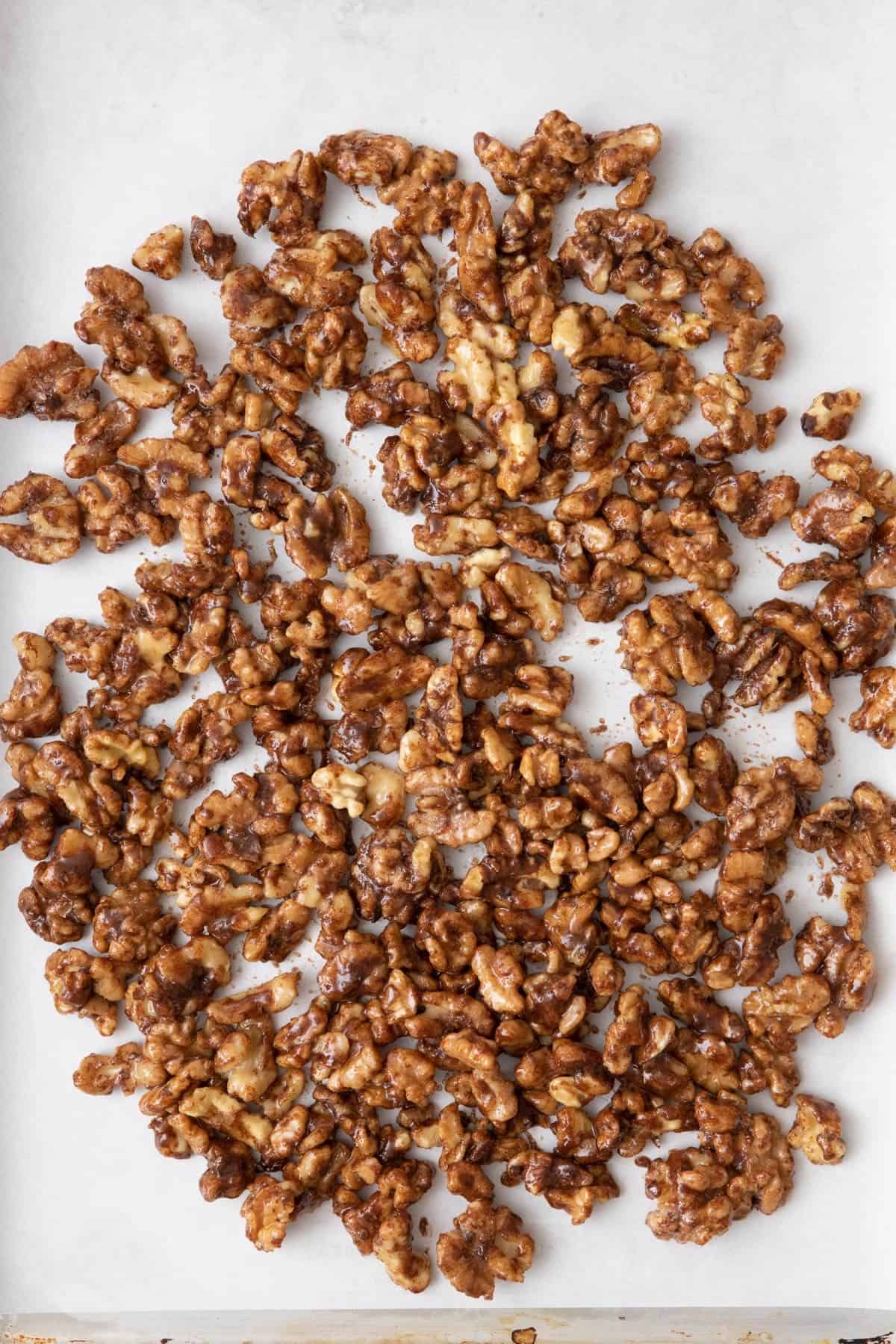 Walnuts on baking sheet before being baked.