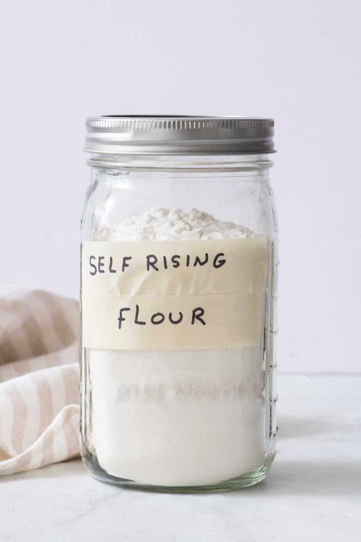Homemade self-rising flour in a mason jar with label.