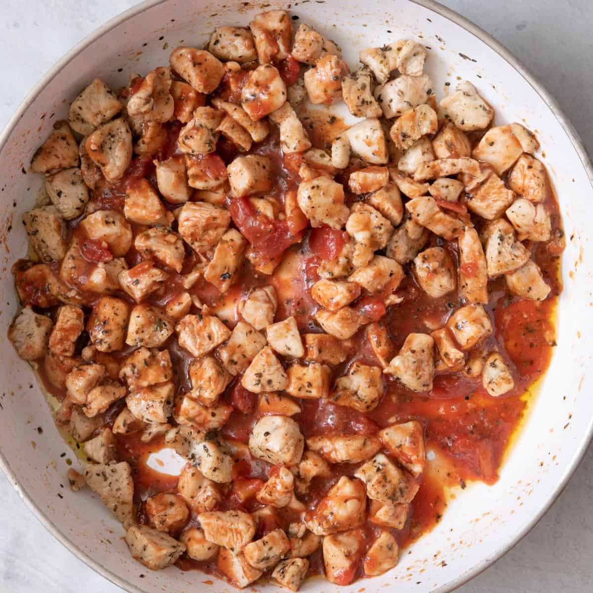 Chicken after cooked with marinara.