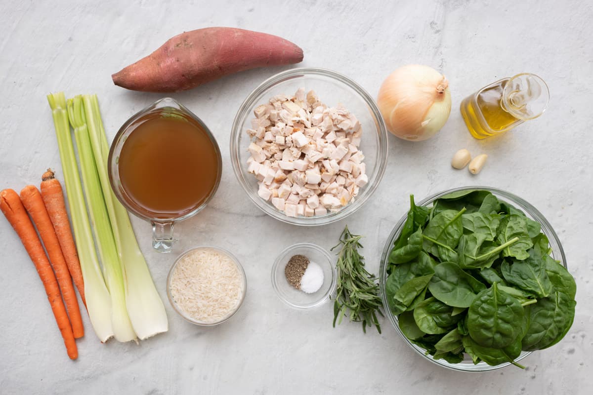 Ingredients for recipe: carrots, celery, sweet potato, broth, rice, cubed leftover turkey, salt and peper, onion, fresh herbs, oil, garlic, and spinach.