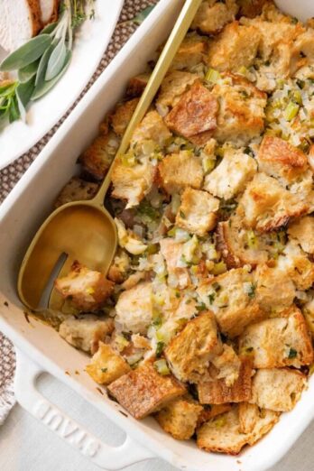 Stuffing in a baking dish with serving spoon.