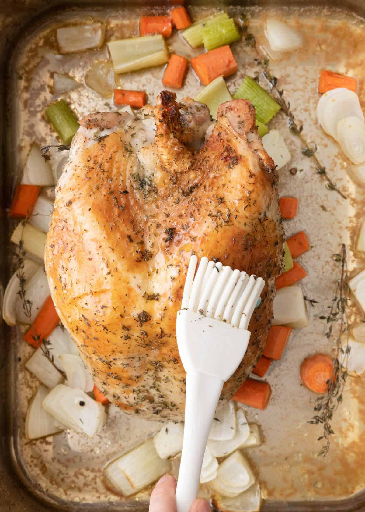 Brushing turkey with butter.