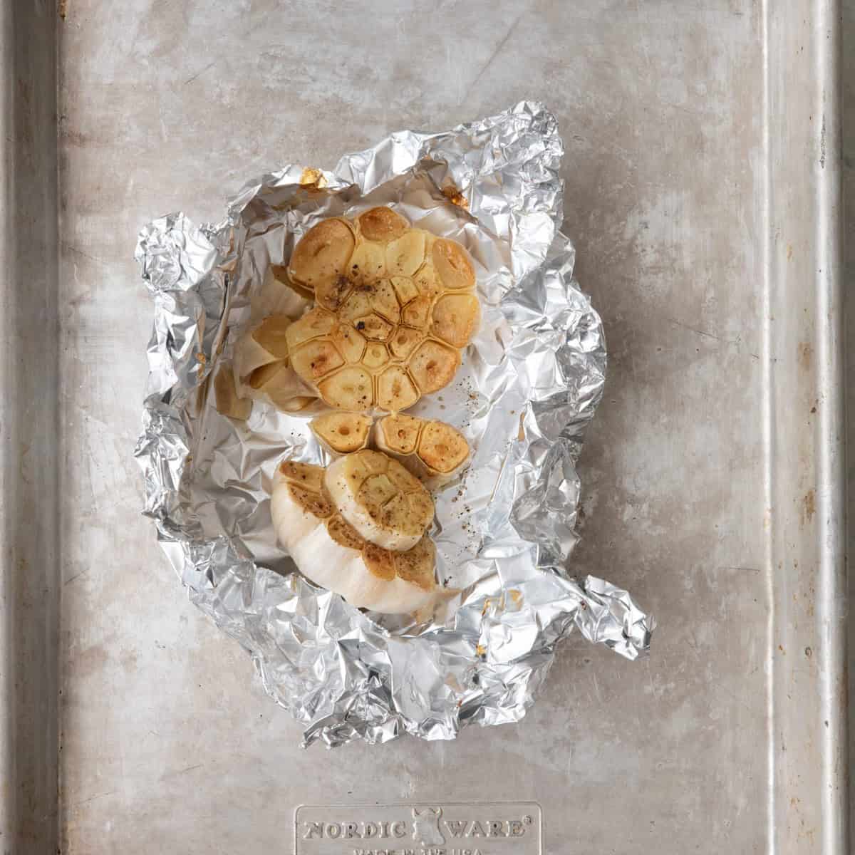 Garlic in foil after being roasted.
