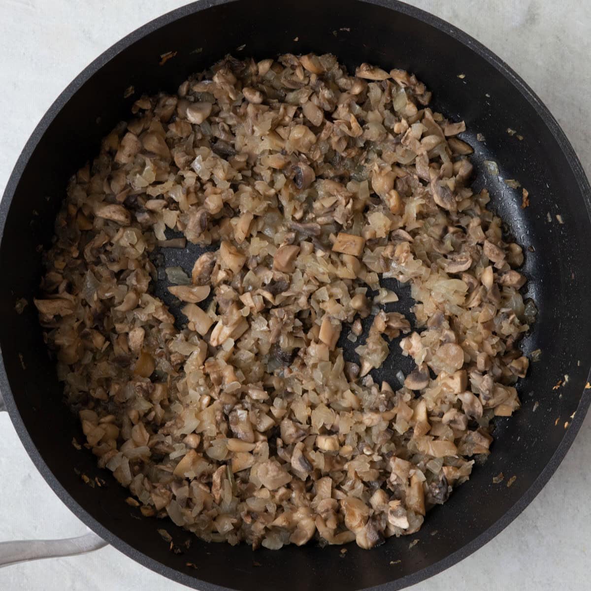 Onions and mushrooms in saucepan.