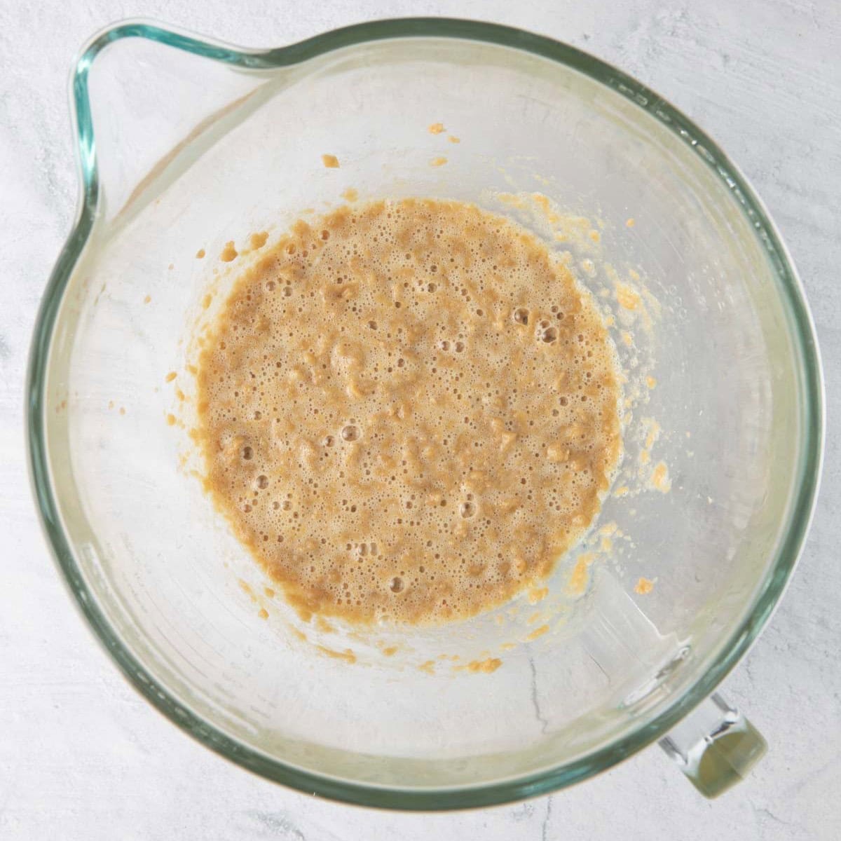 Butter, sugar, and eggs in the bowl of a stand mixer.